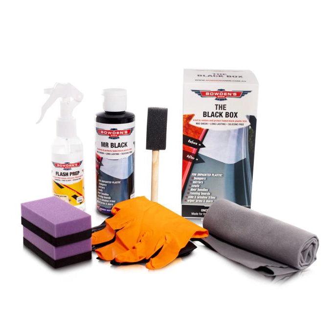 Collection of car care products including spray bottles, sponges, gloves, and a box on a white background.