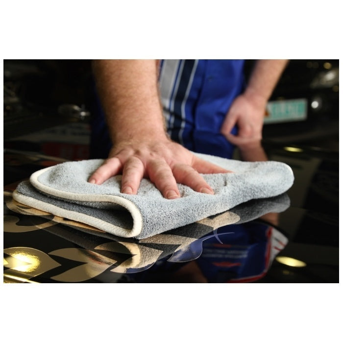 A gray microfiber cloth packaged in a sleeve with branding and product information labels, branded as Bowden's Own Drop Bear for car care. 